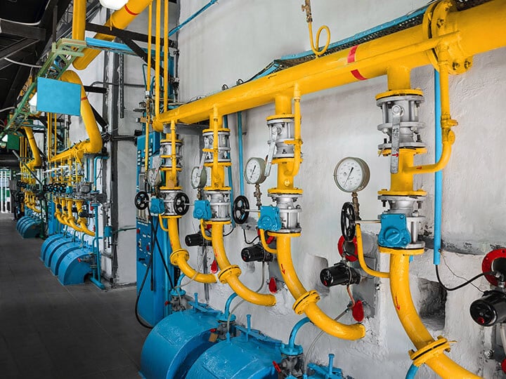 Yellow industrial pipe lines with pressure gauges