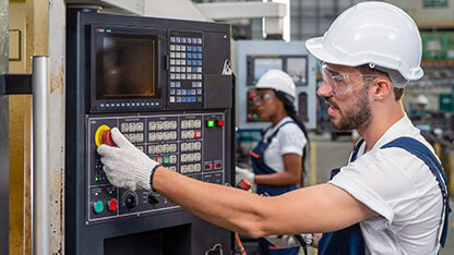 Workers in uniforms work in a production factory