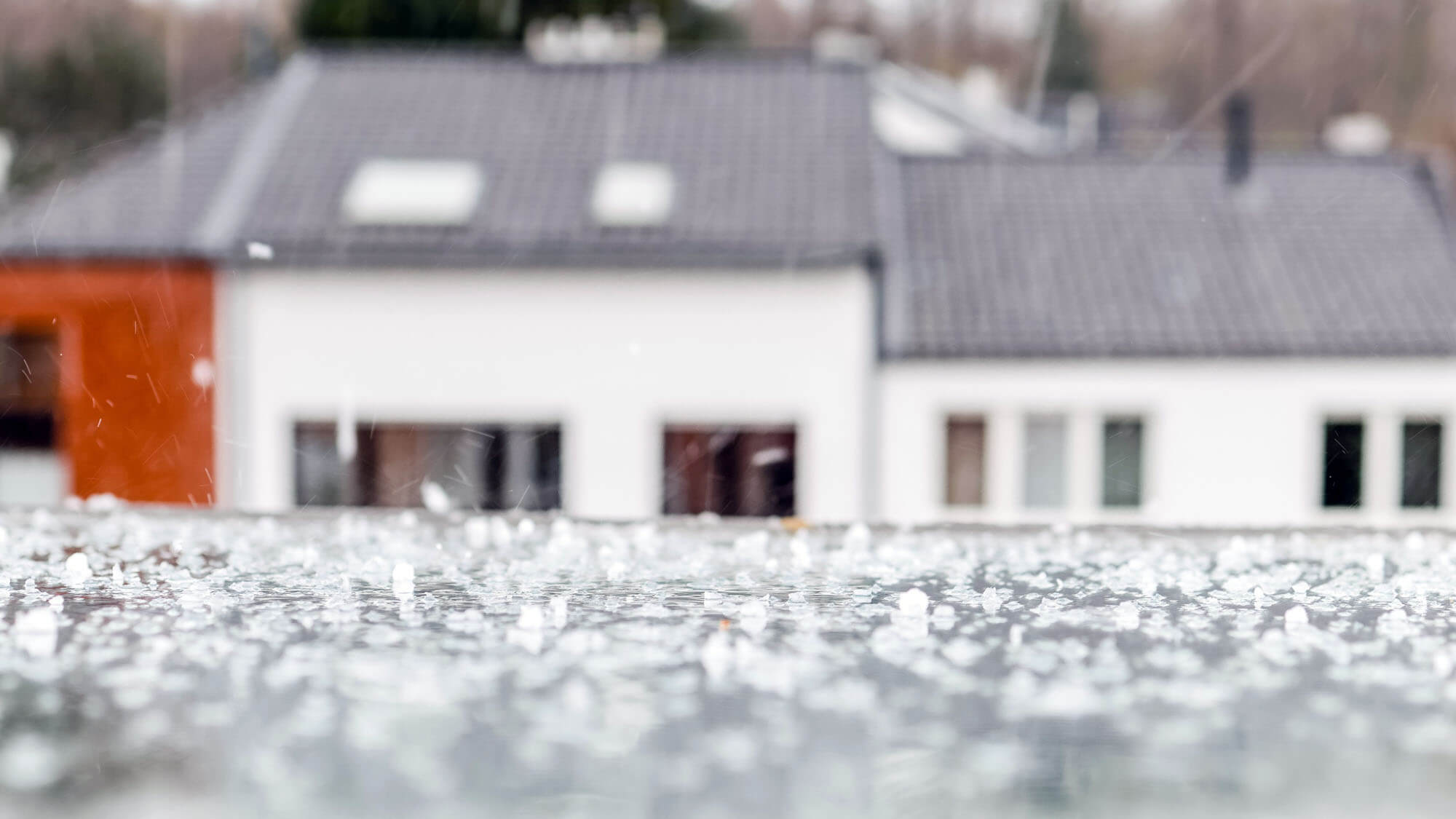 Rain and hail dropping on an attic window