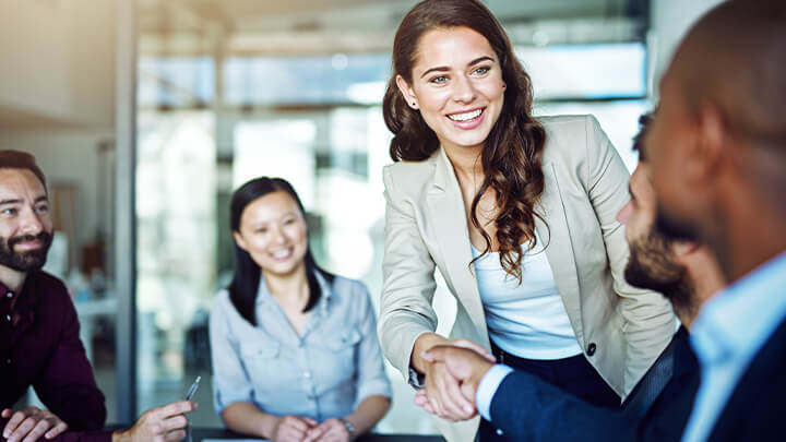 Professionals shaking hands at a table