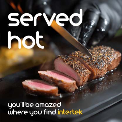 Seasoned beef being sliced on a grill