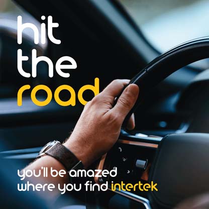 A hand grasping a car steering wheel