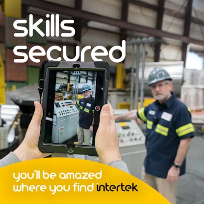 A uniformed factory worker working with machinery viewed through a tablet display
